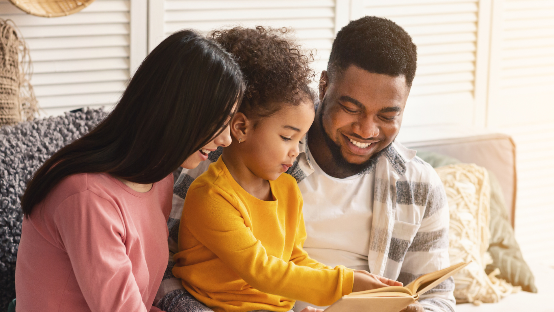 Parents reading with child.