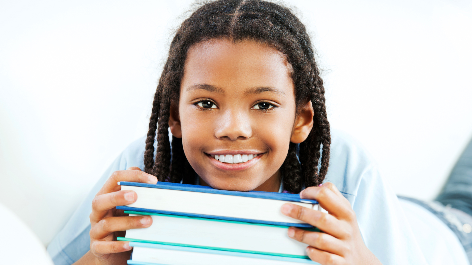 A young boy with books to read and enjoy on his summer break